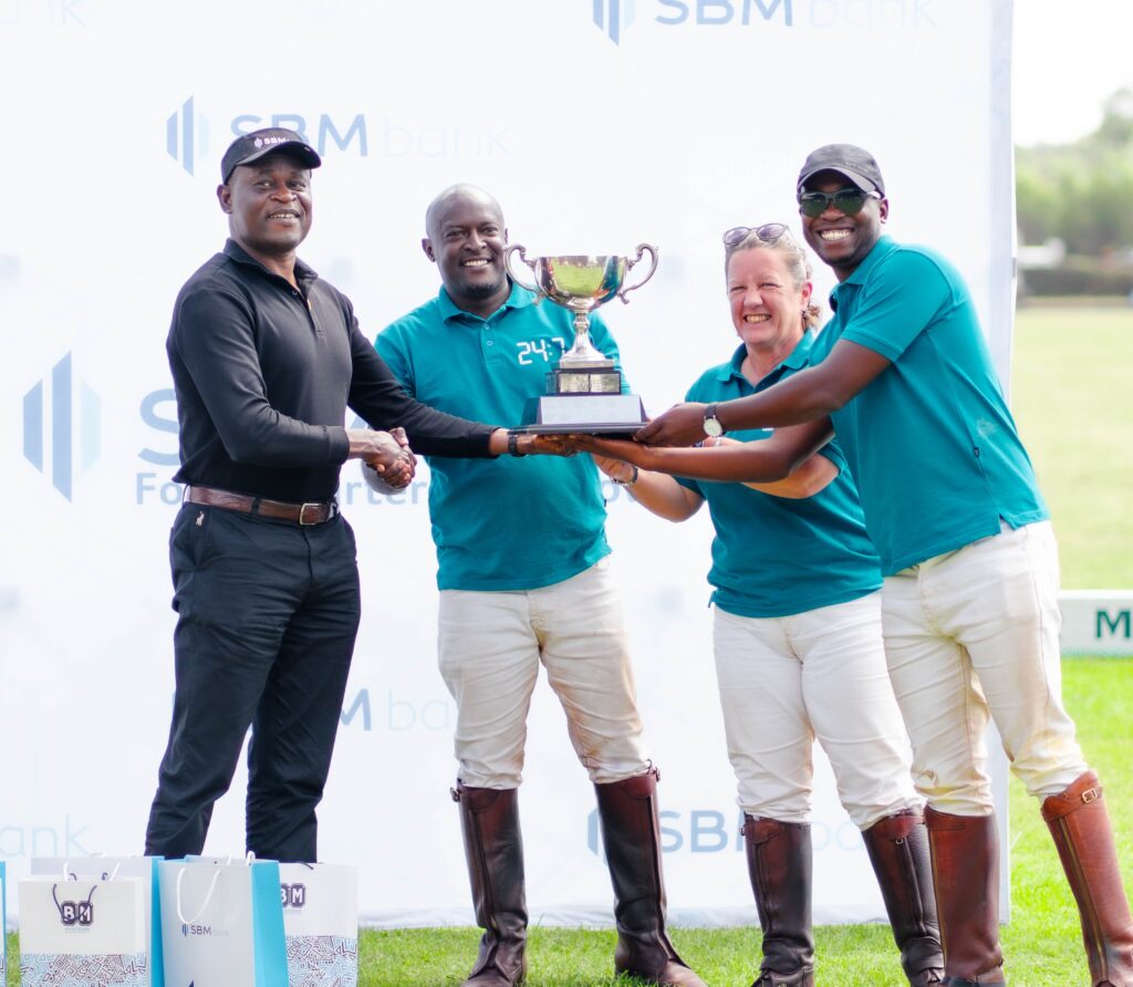 SBM Bank Deputy CEO & CCO, Jotham Mutoka (left), presents the Winner of the Youngest Most Valuable Player (MVP) of the Welby Cup to Archie Camm (right) on July 16th, 2023