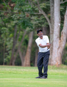 SBM Bank CFO, Mr. Andrew Munyao, watches after striking at the Alliance boys and girls Alumni golf tournament at  the Muthaiga Golf Club.